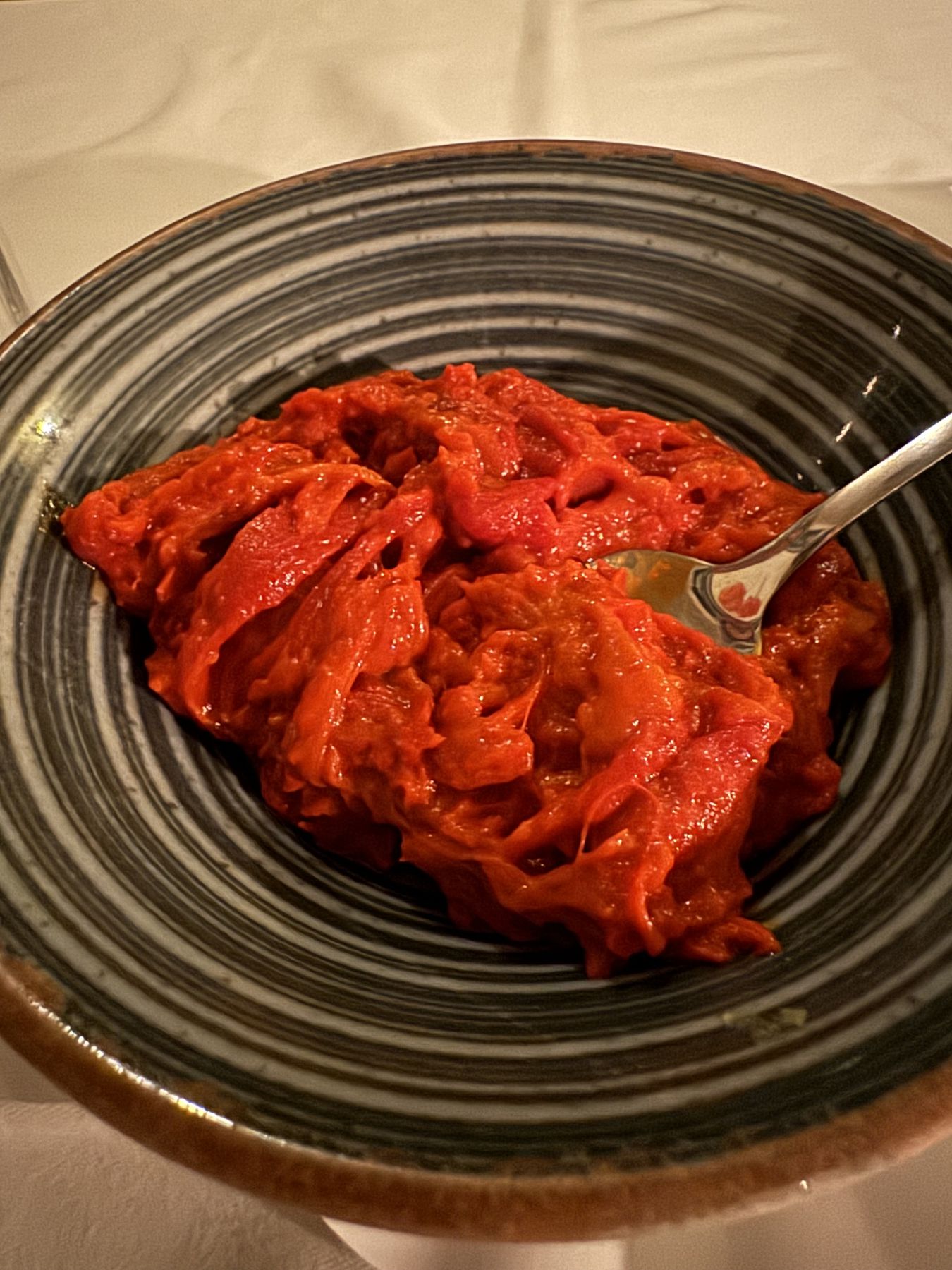 Bowl of bright red ajvar served as a traditional Serbian spread