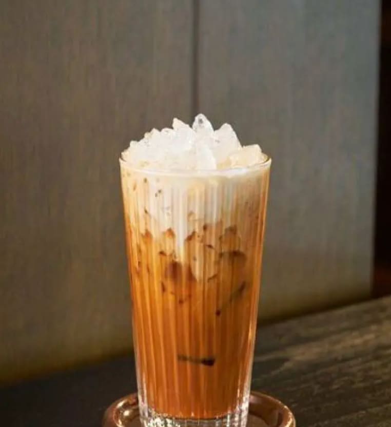 A glass of Thai iced tea over ice
