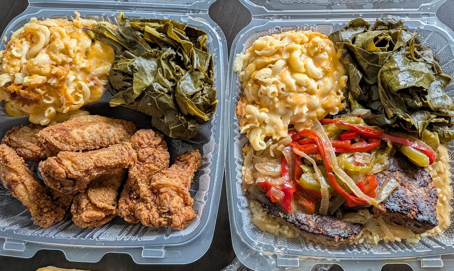 African American soul food spread with fried chicken, macaroni and cheese, greens, rice, and meat
