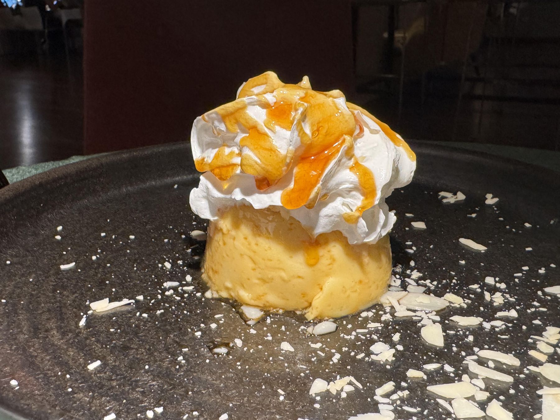 Dubrovnik flan topped with whipped cream and caramel