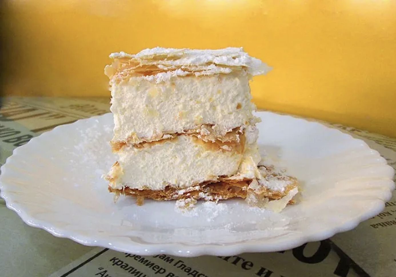 Slice of Krempita cream cake on a plate