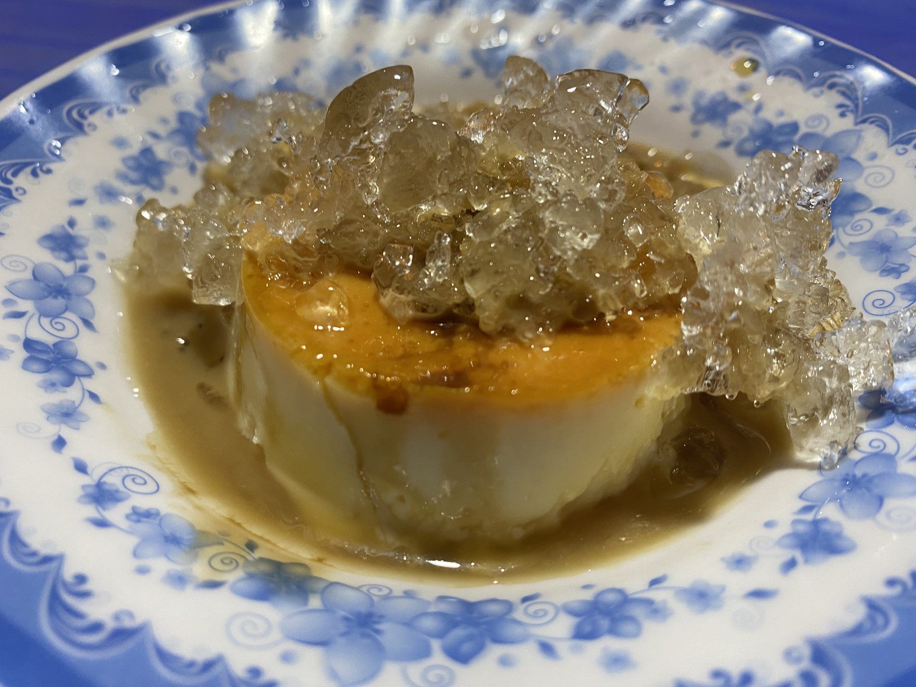 Vietnamese coffee flan topped with crushed ice and caramel