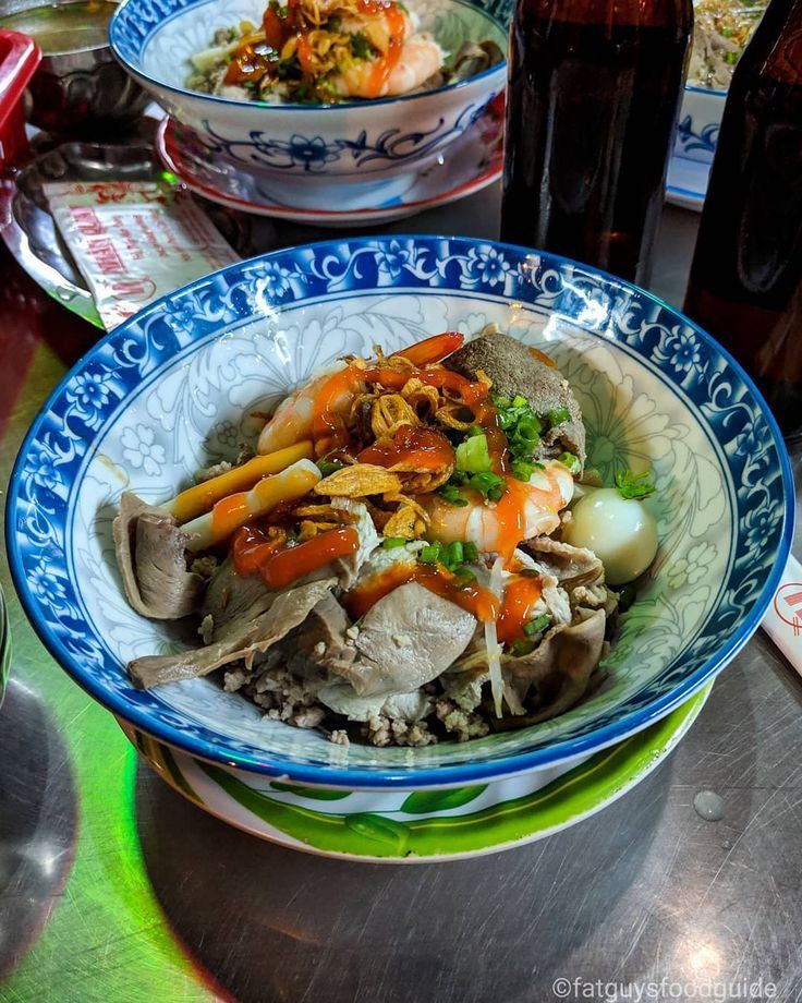 Bowl of hu tieu nam vang with shrimp, pork, quail egg, and toppings