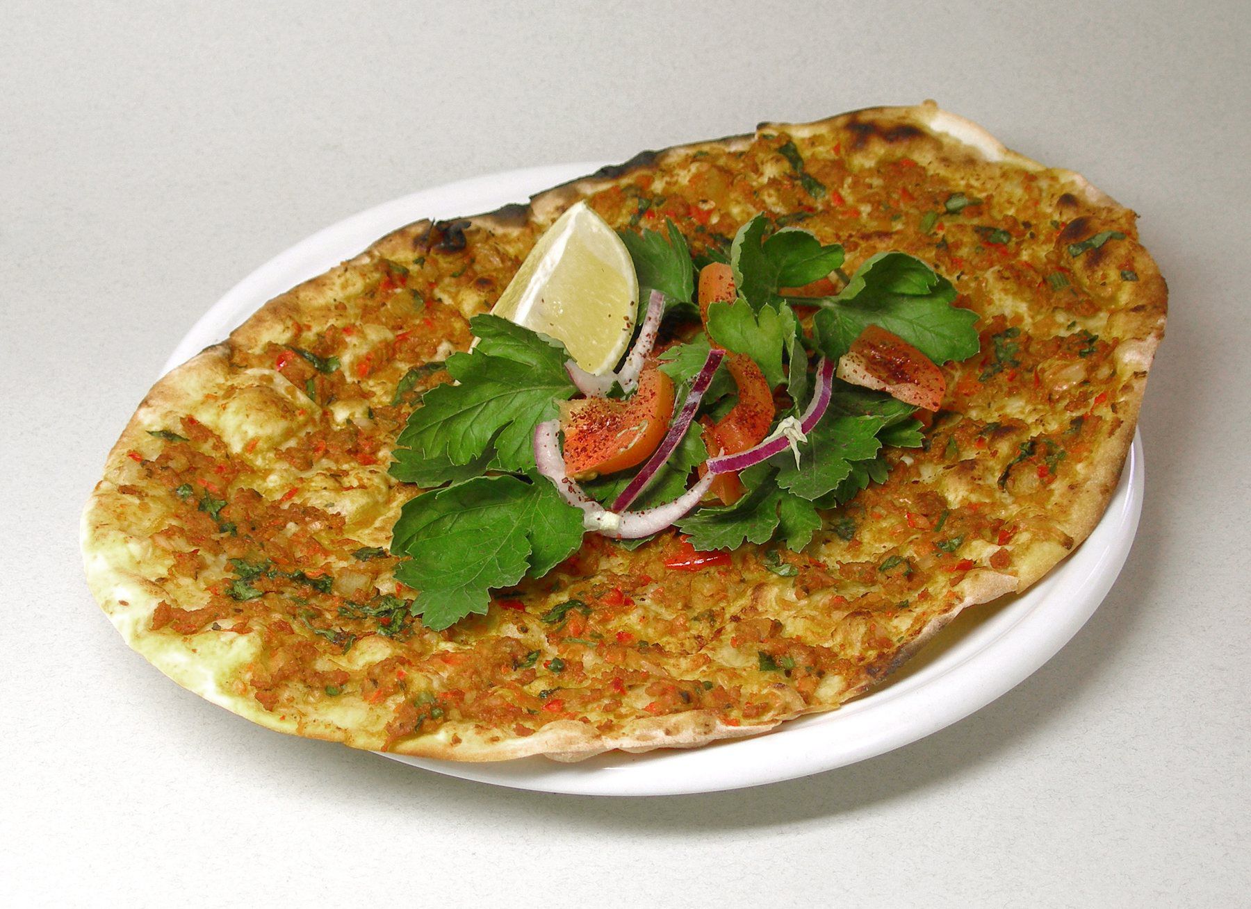 Lahmacun Turkish flatbread topped with minced meat and herbs