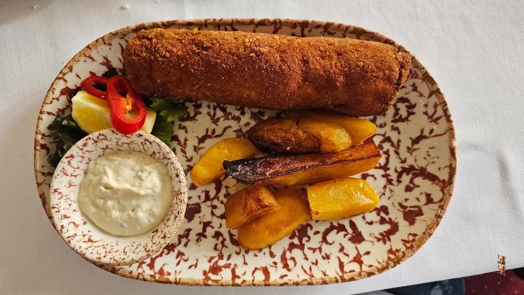 Karađorđeva šnicla served with roasted potatoes and a creamy dipping sauce