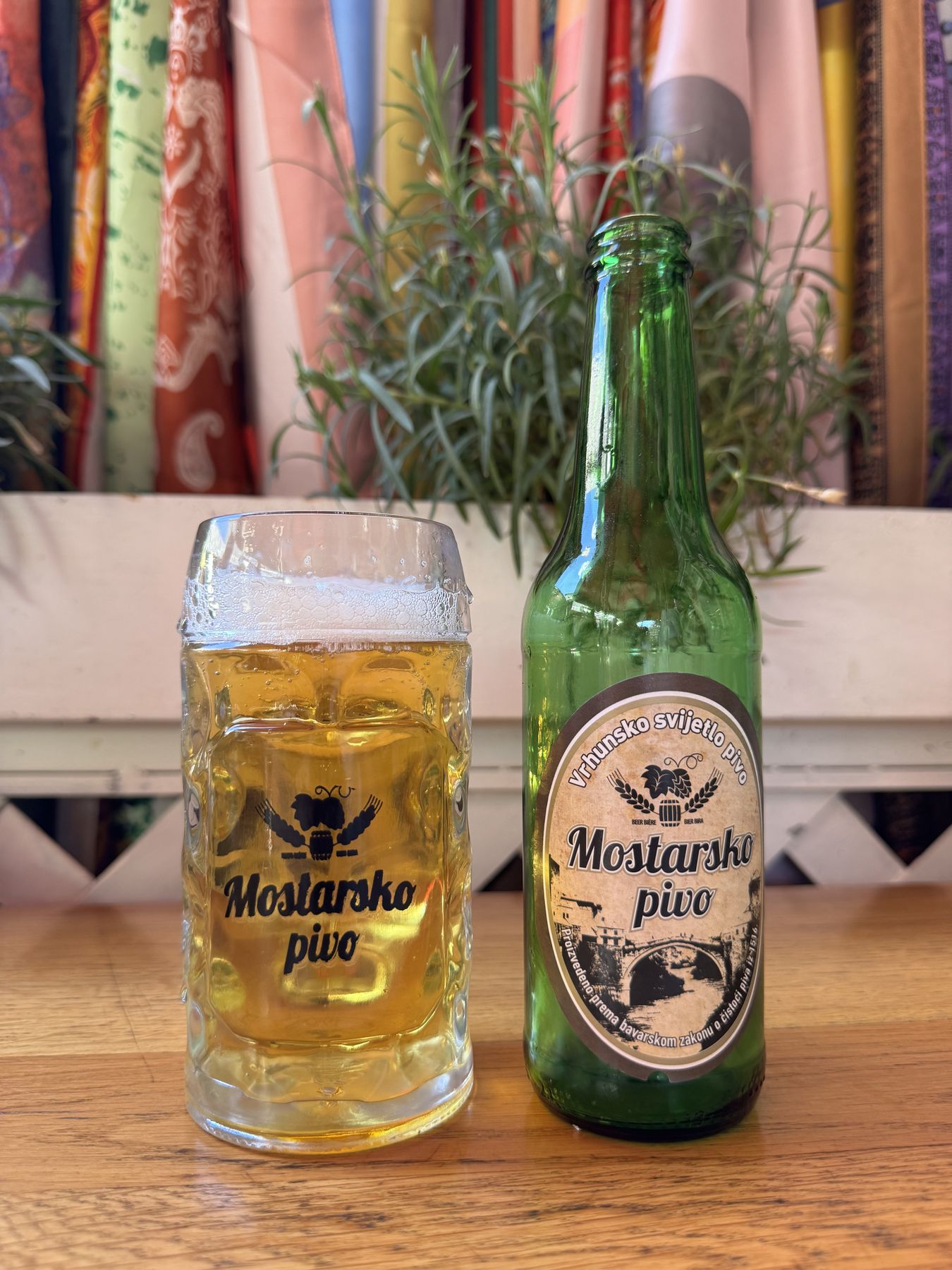 Glass and bottle of Mostarsko pivo on a table in Mostar