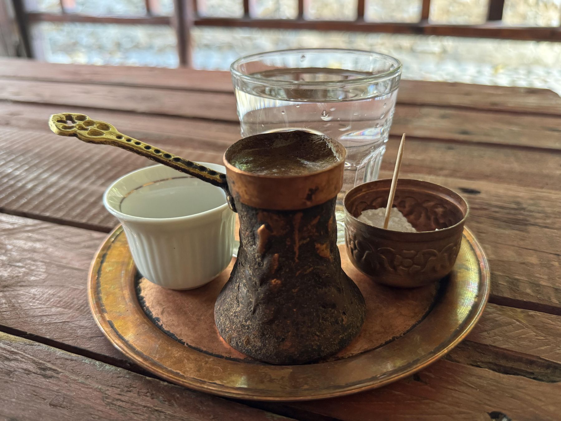 Bosnian coffee service with džezva, cup, sugar, and water in Mostar