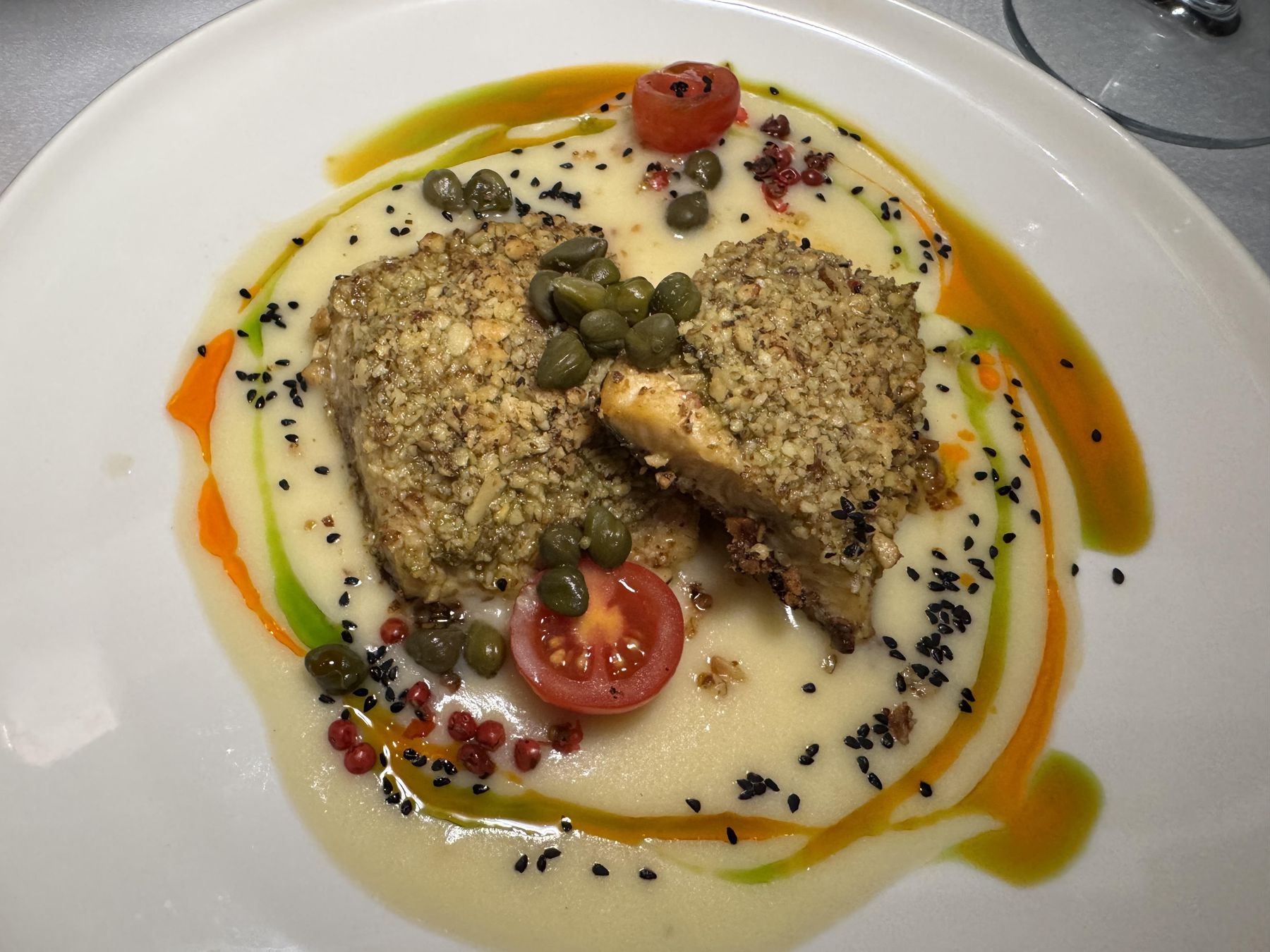 Neretva trout plated over a creamy puree with capers and cherry tomatoes