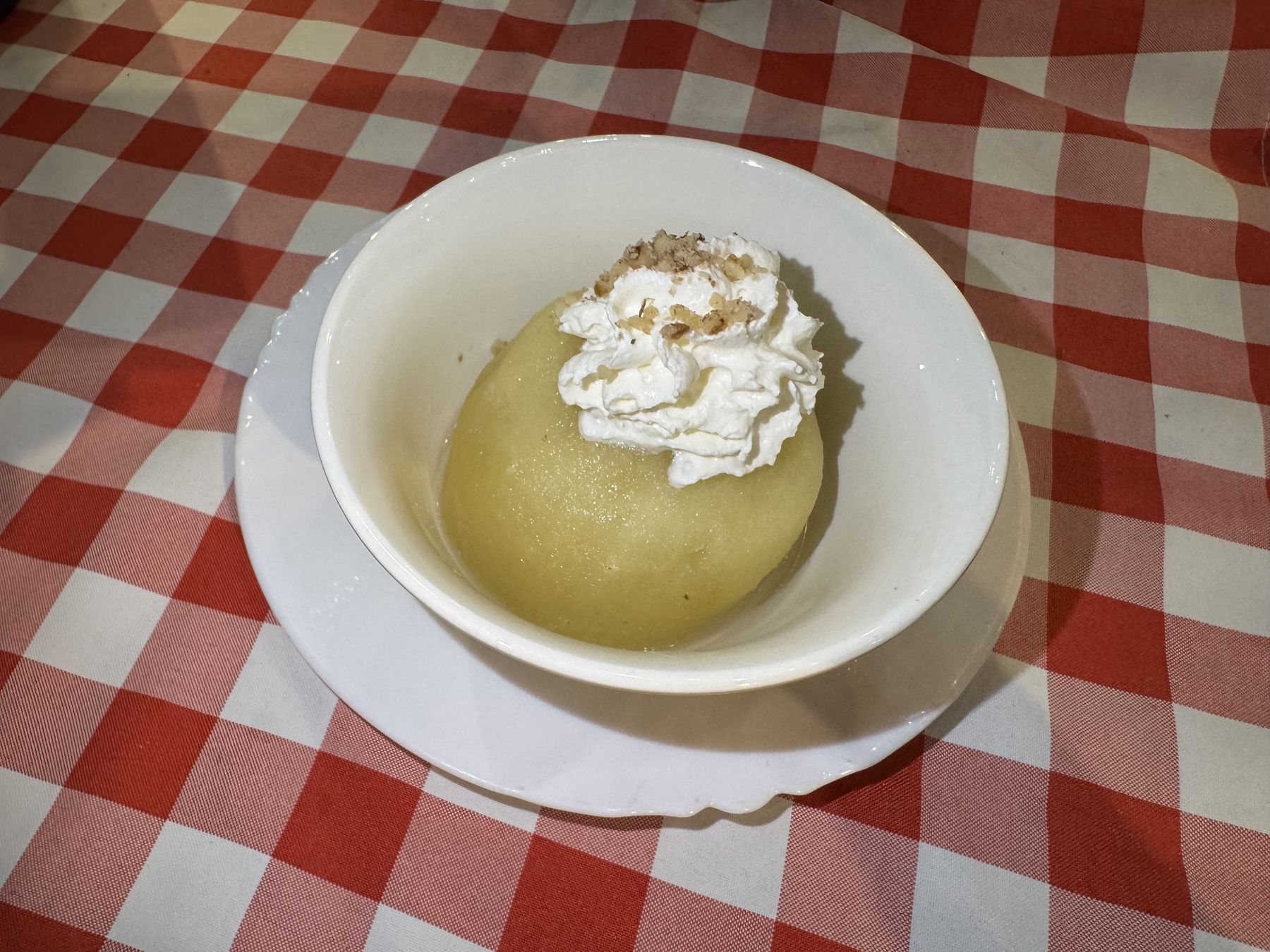 Tufahija served with whipped cream and chopped walnuts in Mostar