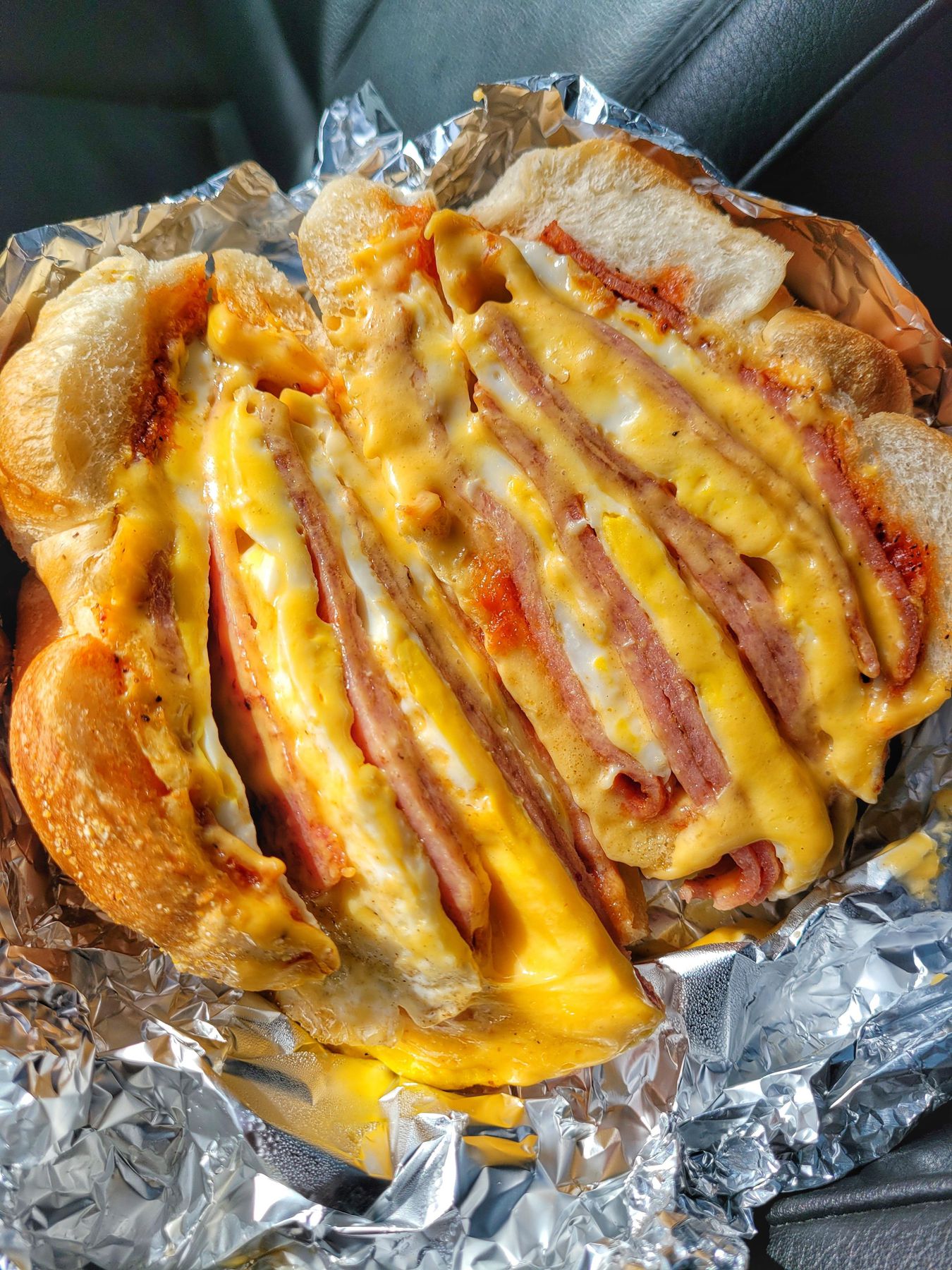 Pork roll, egg, and cheese breakfast sandwich cut open to show layers of meat, egg, and melted cheese