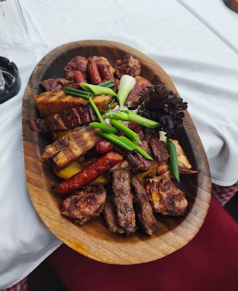 Serbian grilled meat platter with sausages, ribs, and mixed roasted meats