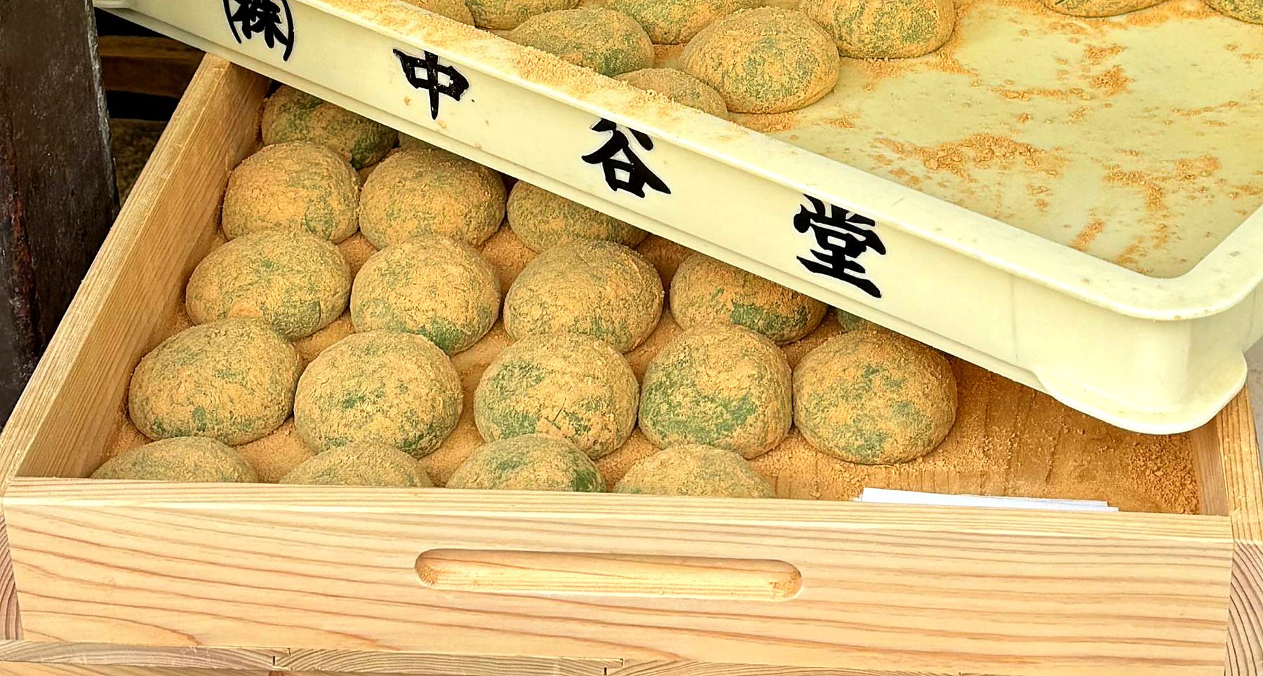 Trays of kinako-dusted mochi rice cakes at a Japanese sweets shop