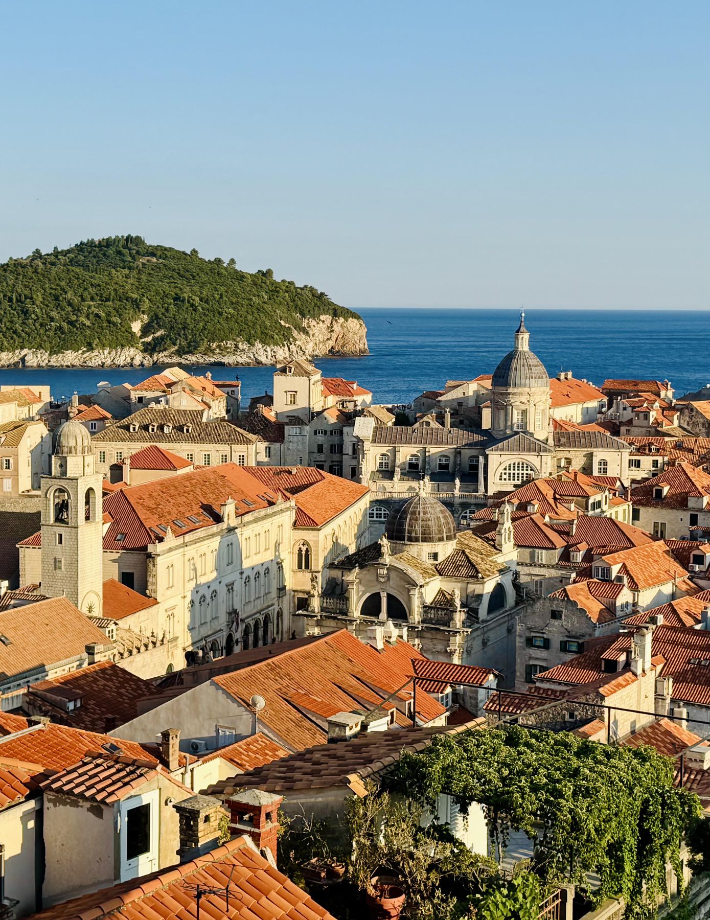 Elevated view over Dubrovnik old town with terracotta roofs and the Adriatic Sea