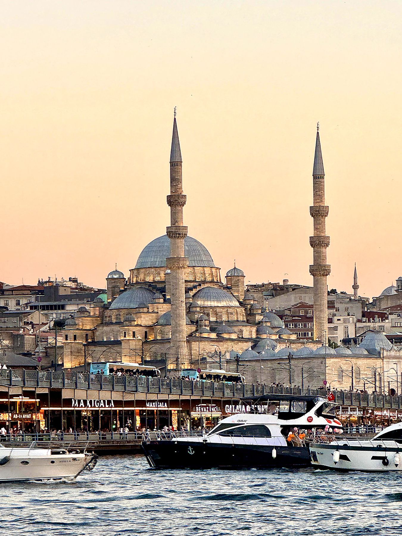Bosphorus ferries and mosque domes at sunset in Istanbul